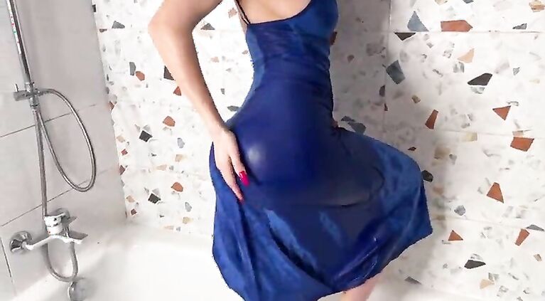 In the shower in a blue seductive dress, I get wet from this pleasant water and masturbate with a glass dildo