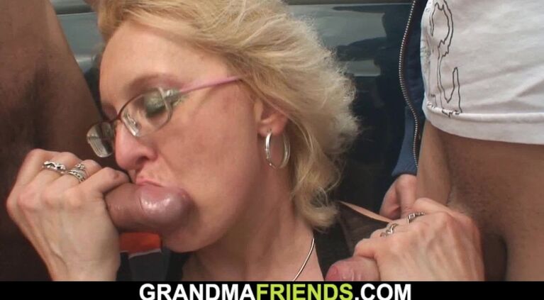 Working mature woman swallows two cocks