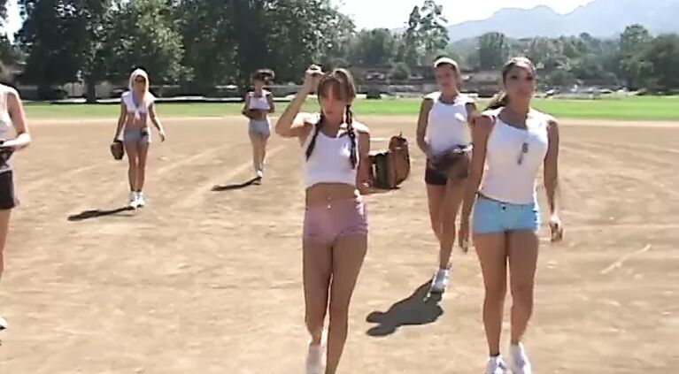 Coach shows 2 female athletes how to properly handle a big bat