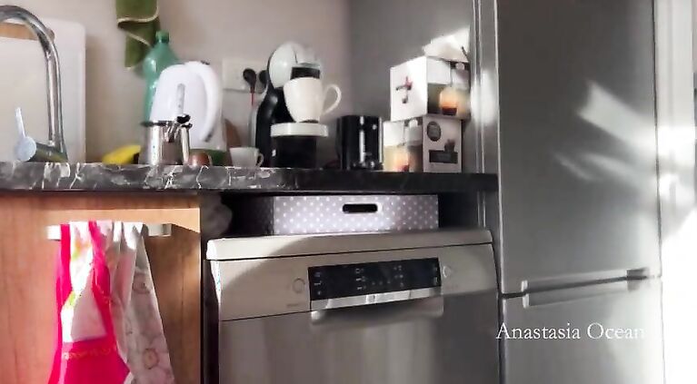 Sunny morning and she is making coffee in stokings and hills. Voyeurism.